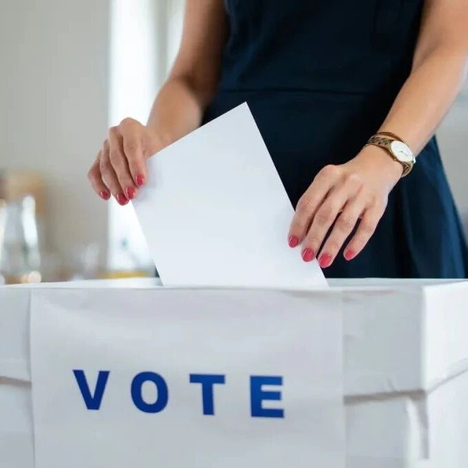 How do economic barriers limit women's political participation?